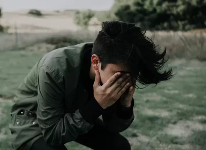 the woman covers her face with her hands